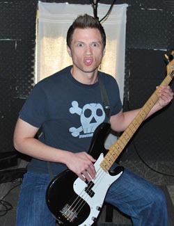 Peter J Hopkins playing bass and scowling